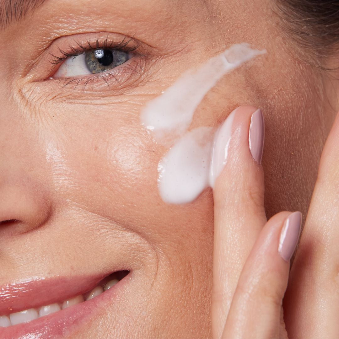 Woman applying Youth Renewal Peptide Cream to deeply hydrate her skin