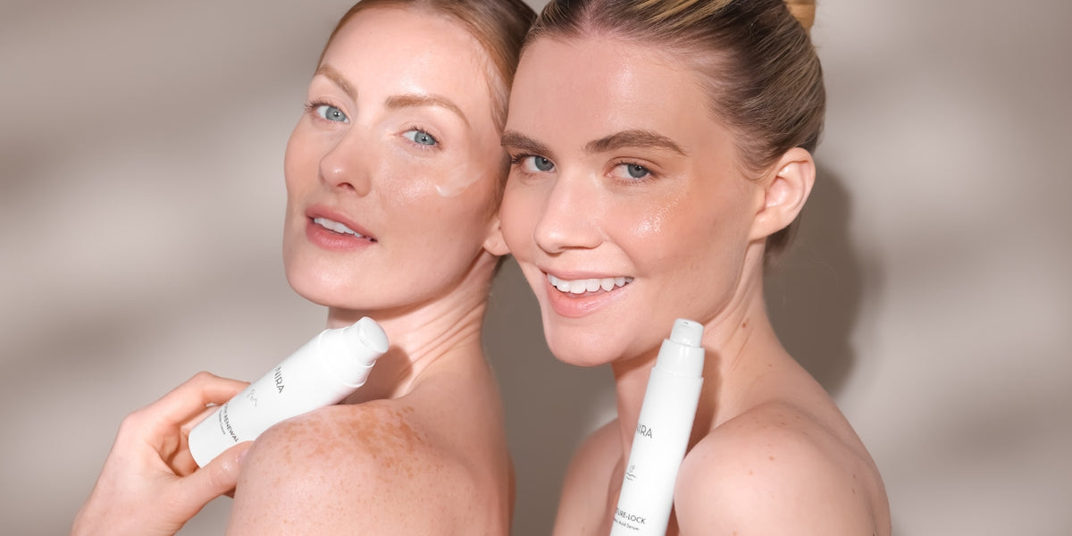  Two women with wrinkle-free skin holding anti-aging skincare products to reduce forehead lines
